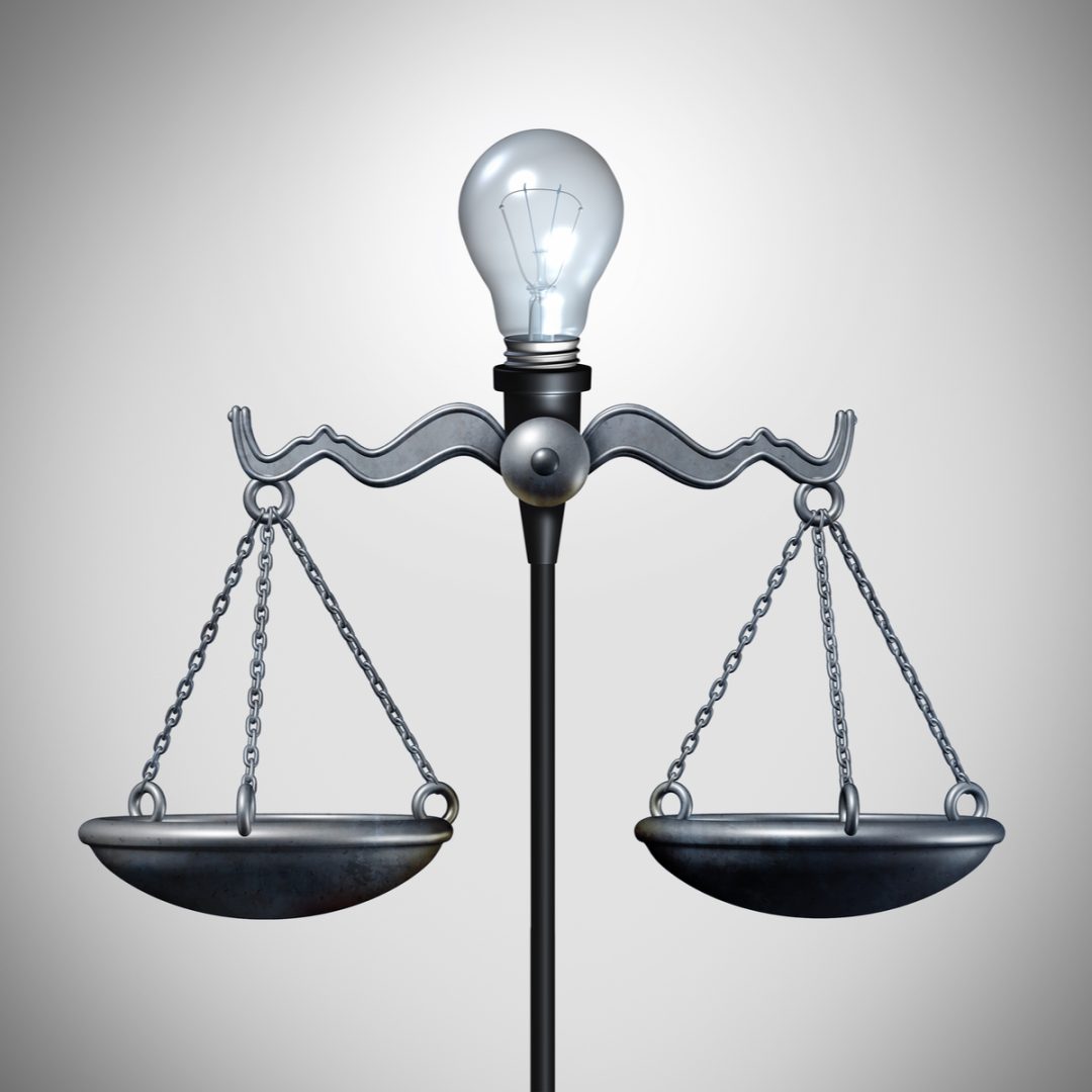 Scales of Justice with lightbulb of invention