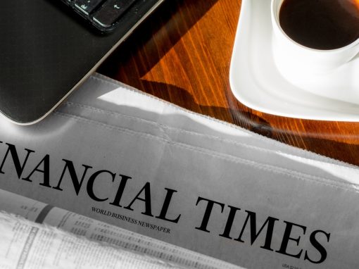 Financial Times paper on desk with coffee and keyboard
